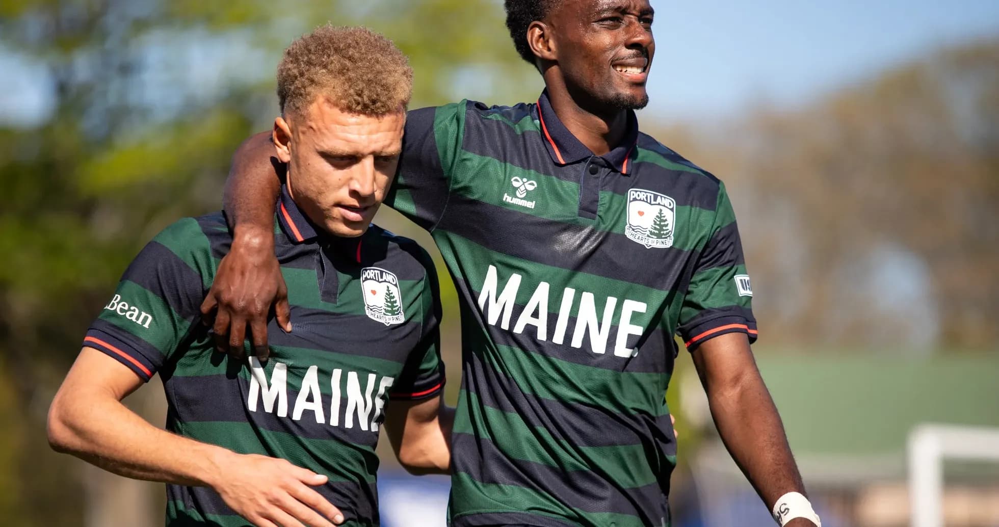 Two Portland players celebrating on the field