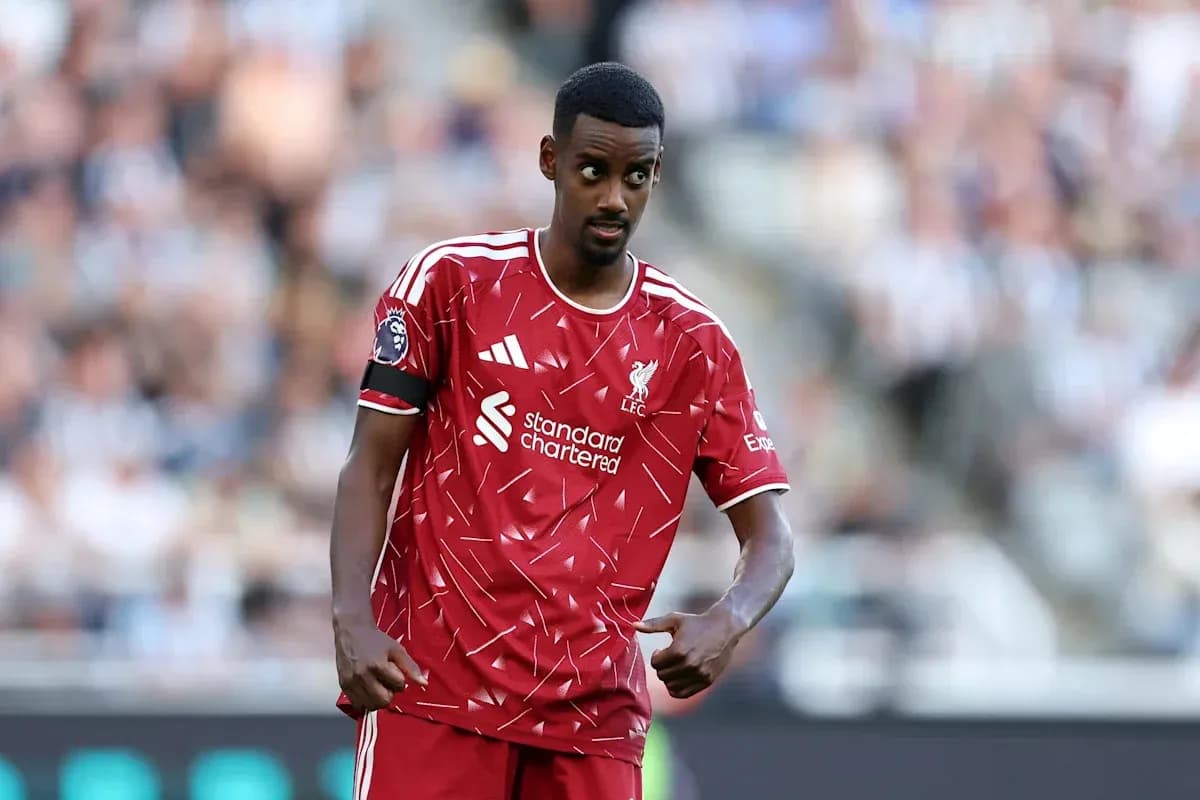 Player in Liverpool kit gesturing during match