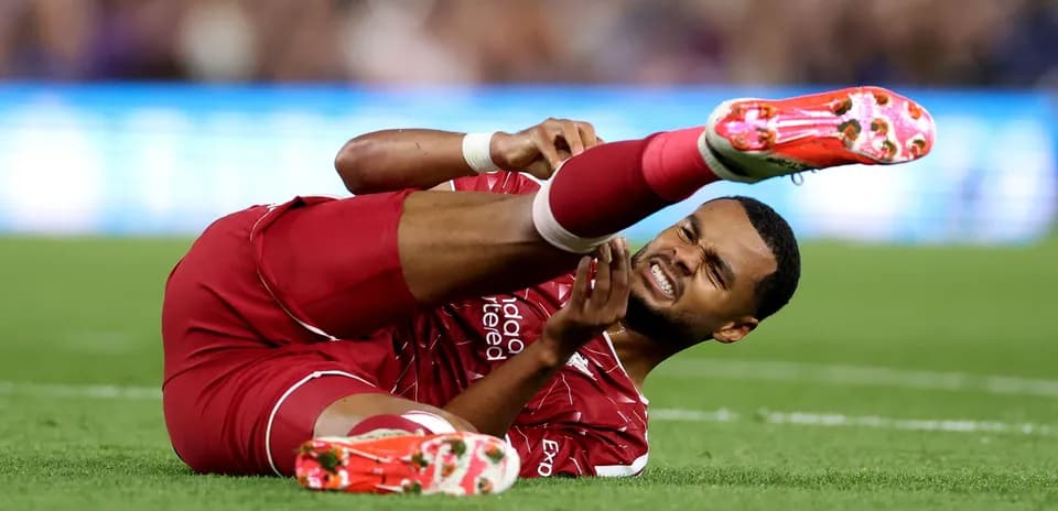 Player on ground holding injured leg during match