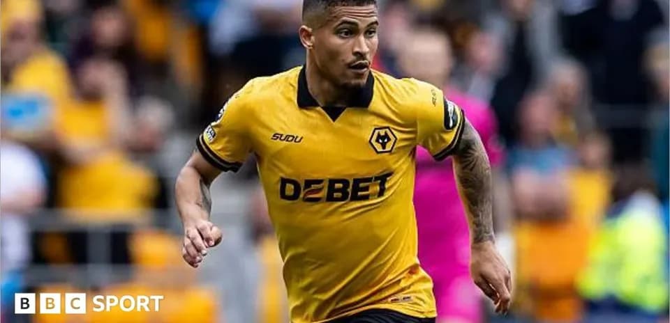 Player running in yellow Wolves jersey during match