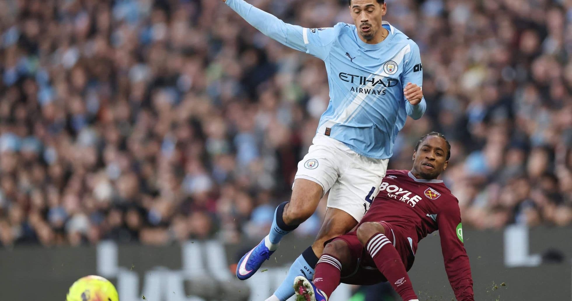 West Ham player tackling Manchester City opponent