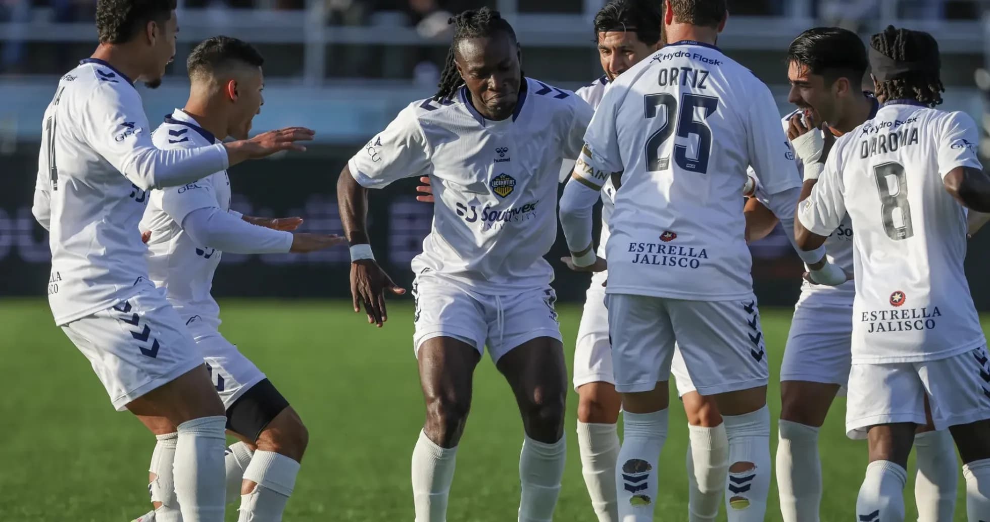 Players celebrating a goal during match