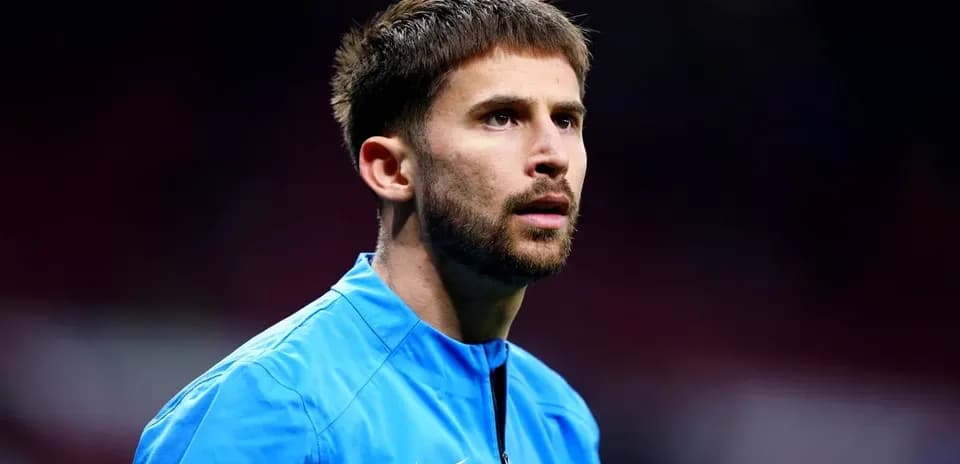 Player in blue kit during match warm-up