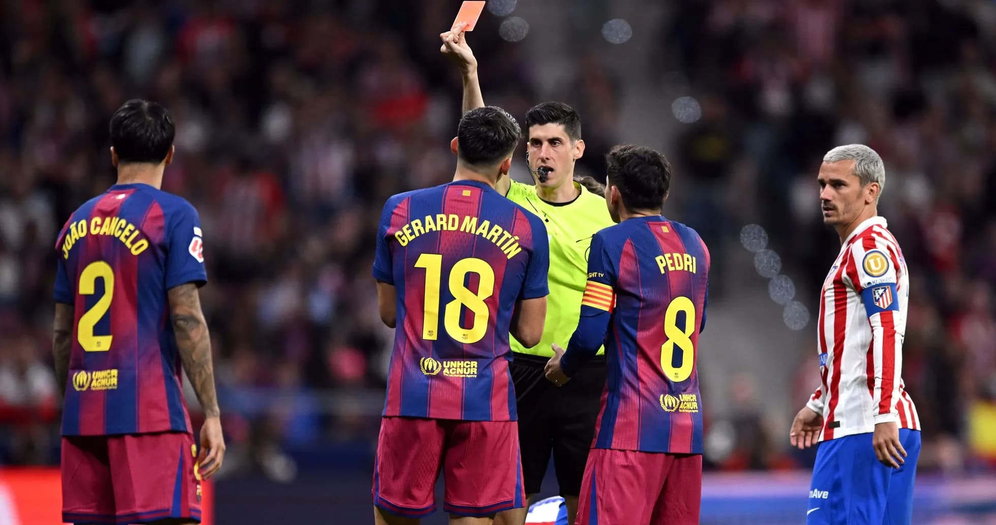 Referee shows red card to Barcelona player during match