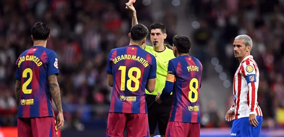 Referee shows red card to Barcelona player during match