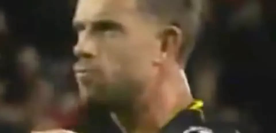 Player reacting during a match in dark uniform