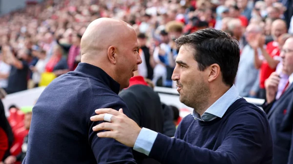 Two coaches greeting each other before the match