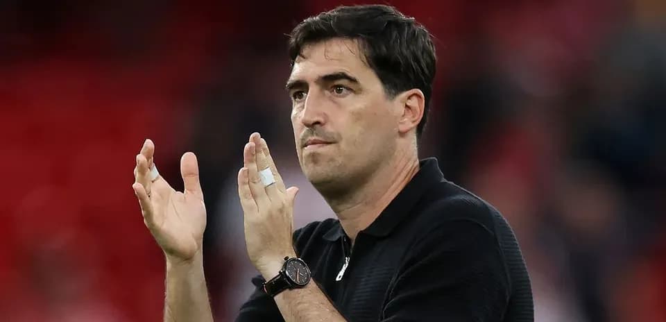 Coach applauding in stadium after match