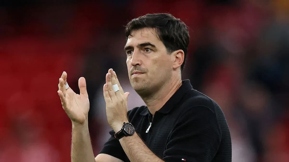 Coach applauding in stadium after match