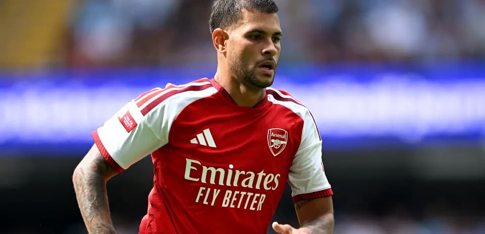 Player in Arsenal jersey running on the field