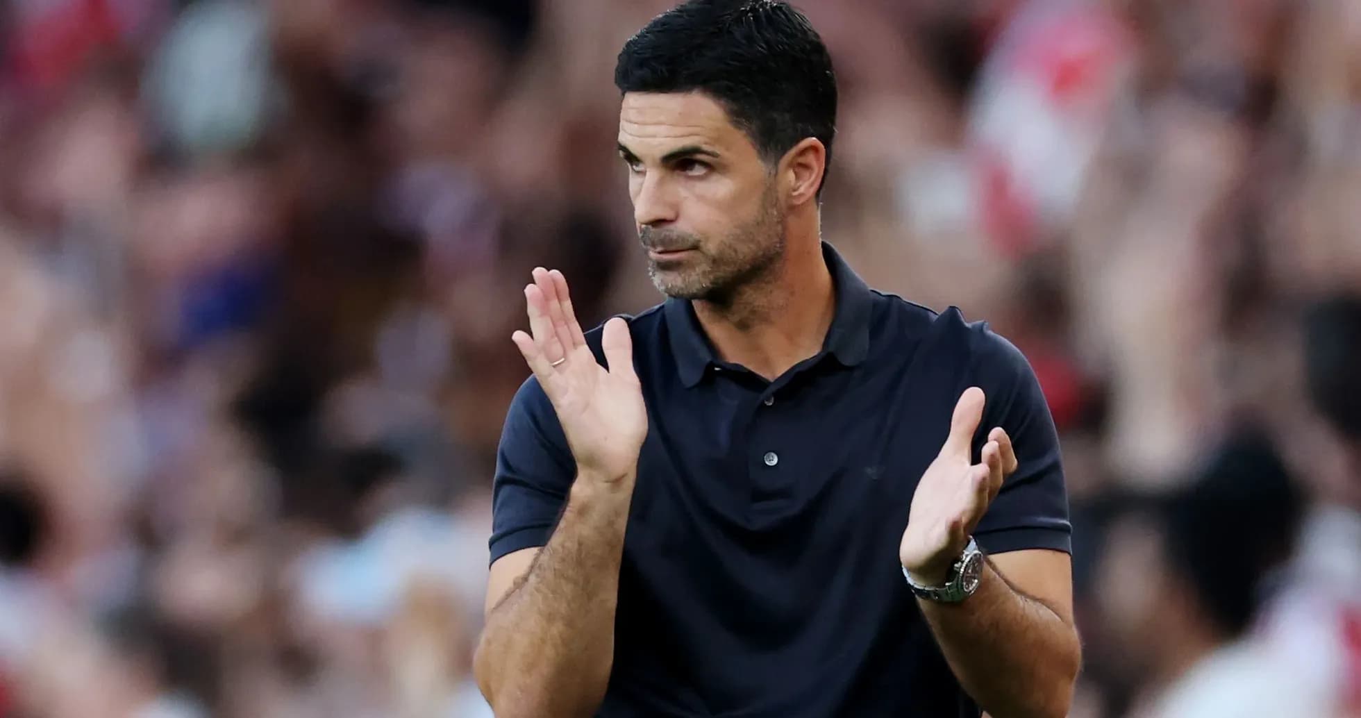 Coach applauding during a match on the sidelines