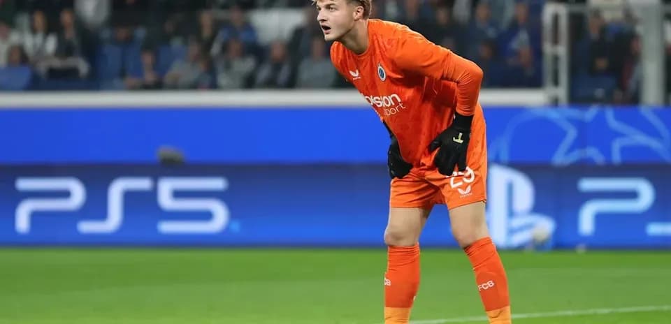 Goalkeeper in orange kit during match action