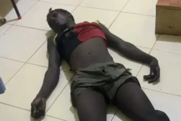 Person lying on the floor in casual clothing