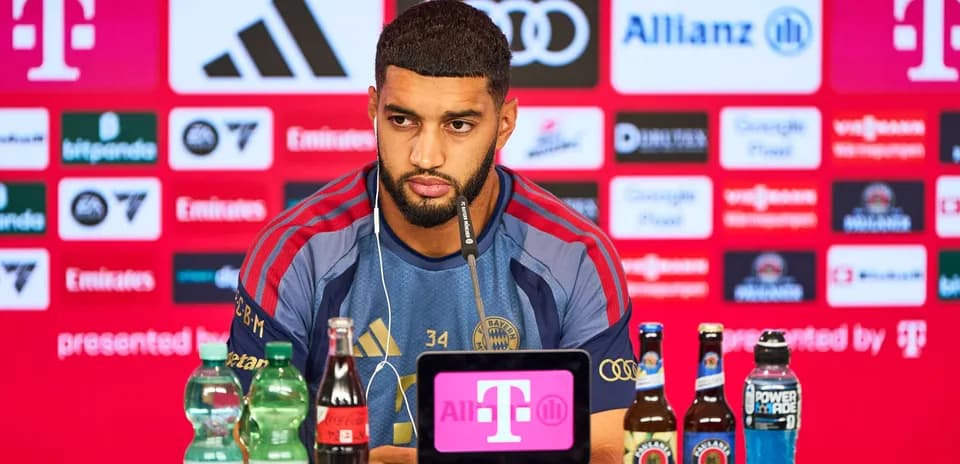 Player speaking at press conference with drinks displayed