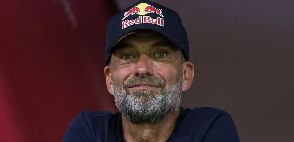 Coach wearing a Red Bull cap during event