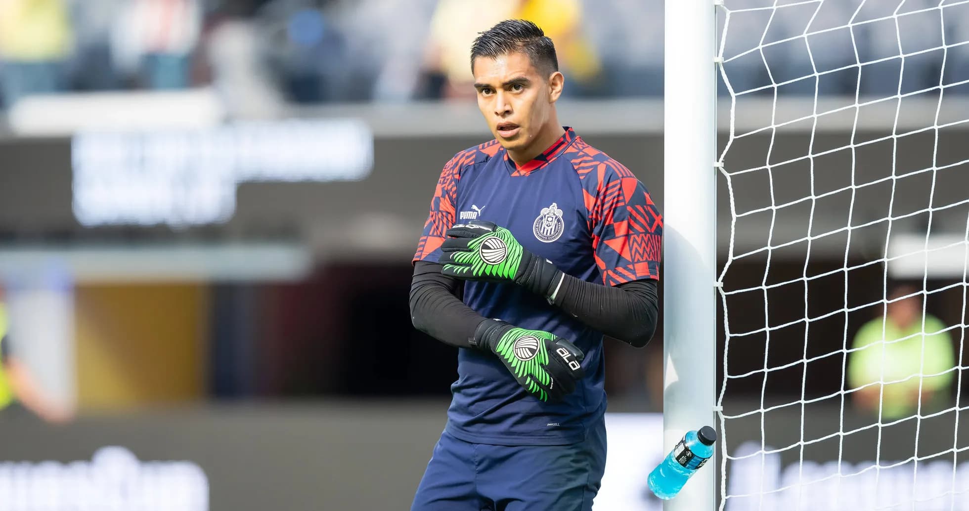Goalkeeper warming up near the goalpost