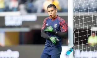 Goalkeeper warming up near the goalpost