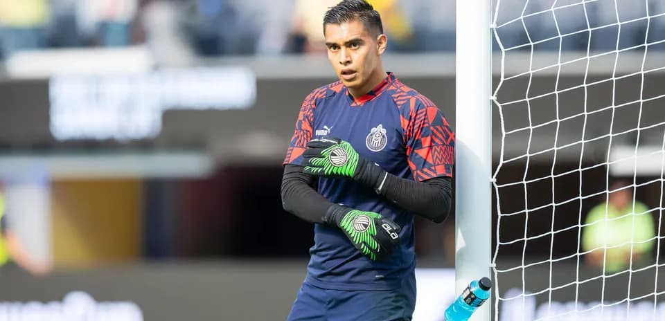 Goalkeeper warming up near the goalpost