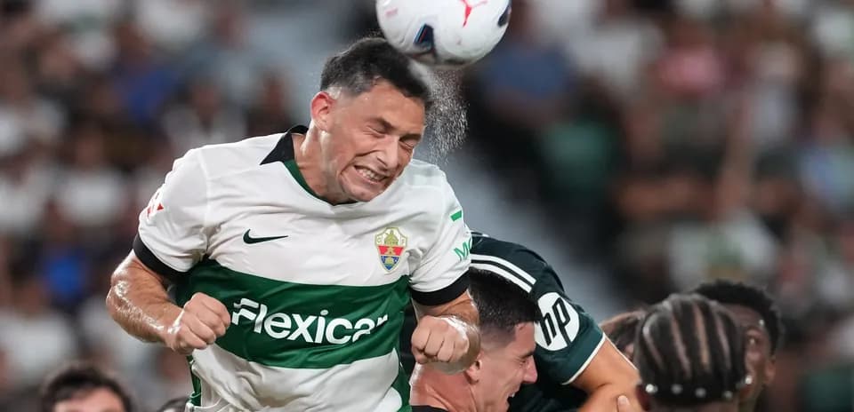 Elche player heading the ball in match