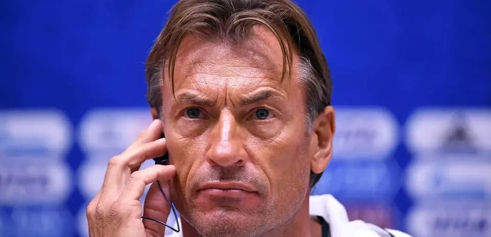 Coach speaking into a headset at press conference