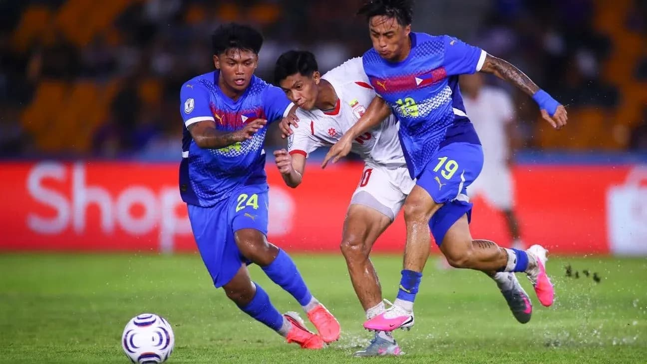 Two players tackling an opponent during a match