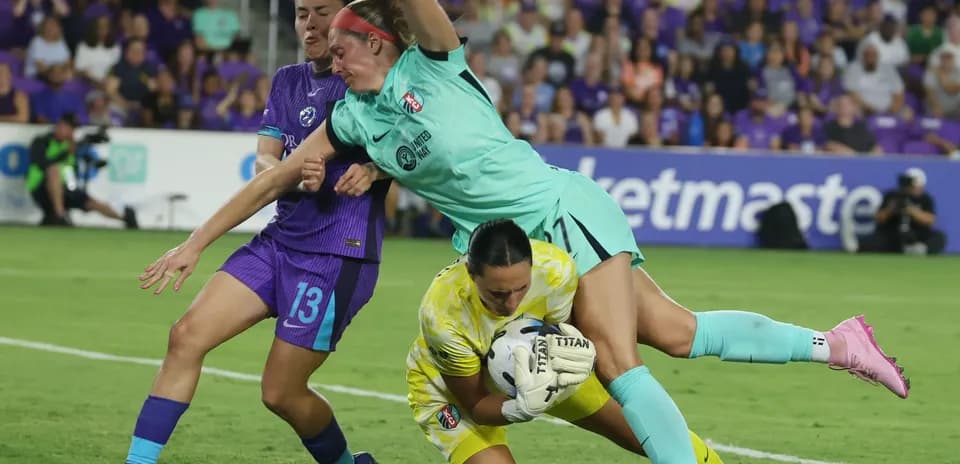 Goalkeeper diving to save the ball during match