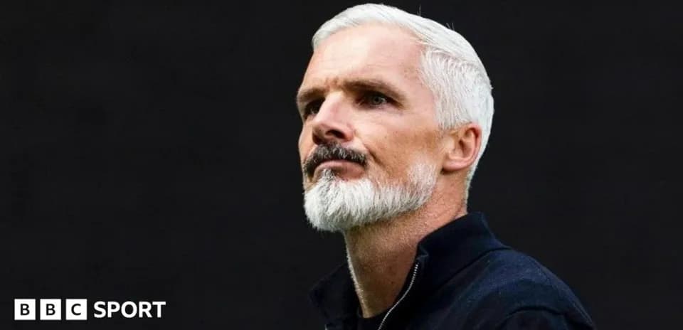 Man with silver hair and beard looking thoughtfully