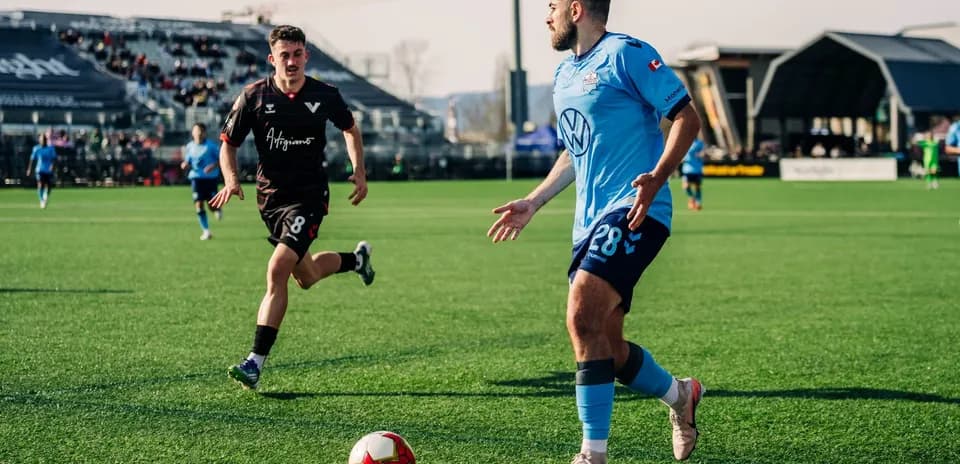 Players competing for the ball in football match