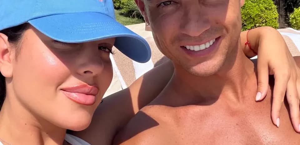 Couple posing together by the poolside