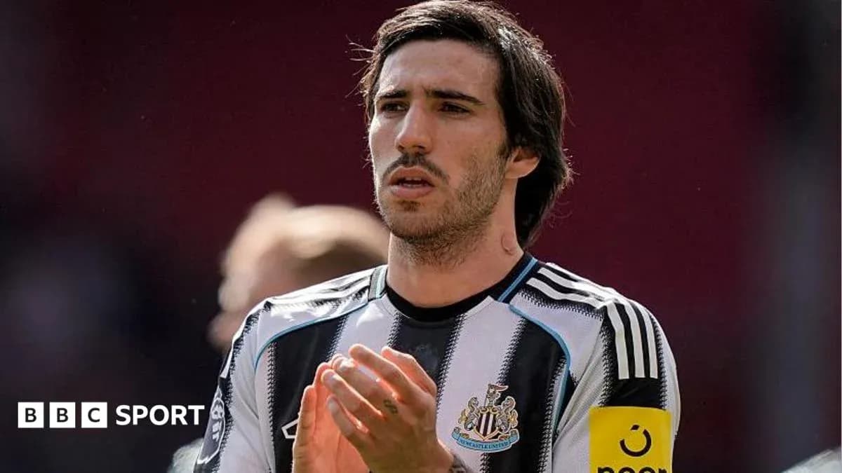 Player applauding while wearing Newcastle United jersey