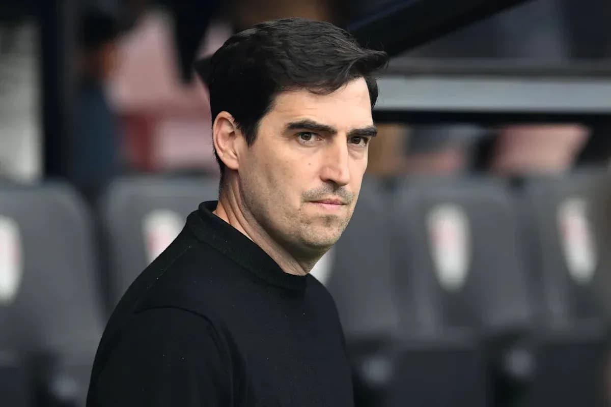 Coach observing from the sidelines during match