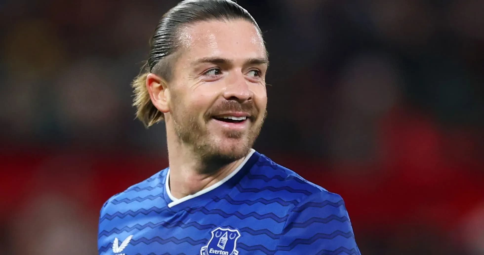 Player smiling in Everton jersey during match