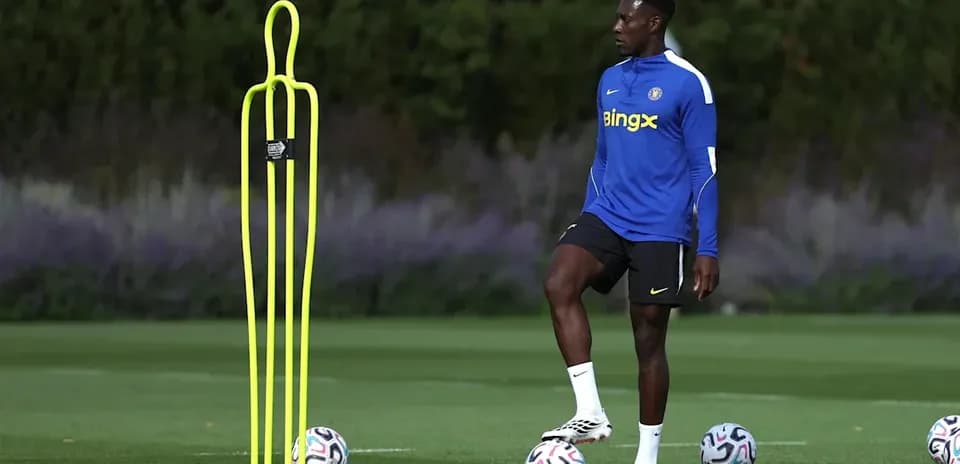 Player practicing with training cones and footballs