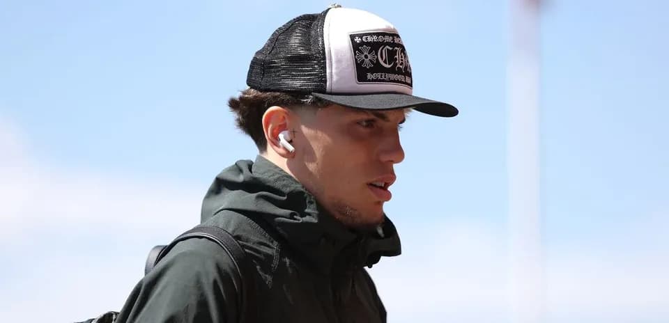 Athlete wearing cap and earbuds walking outdoors