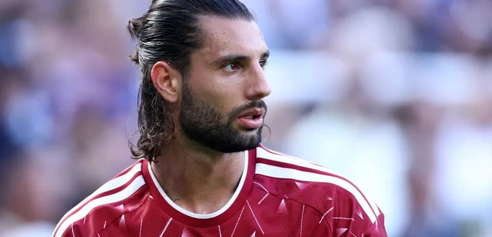 Football player wearing Liverpool jersey during match