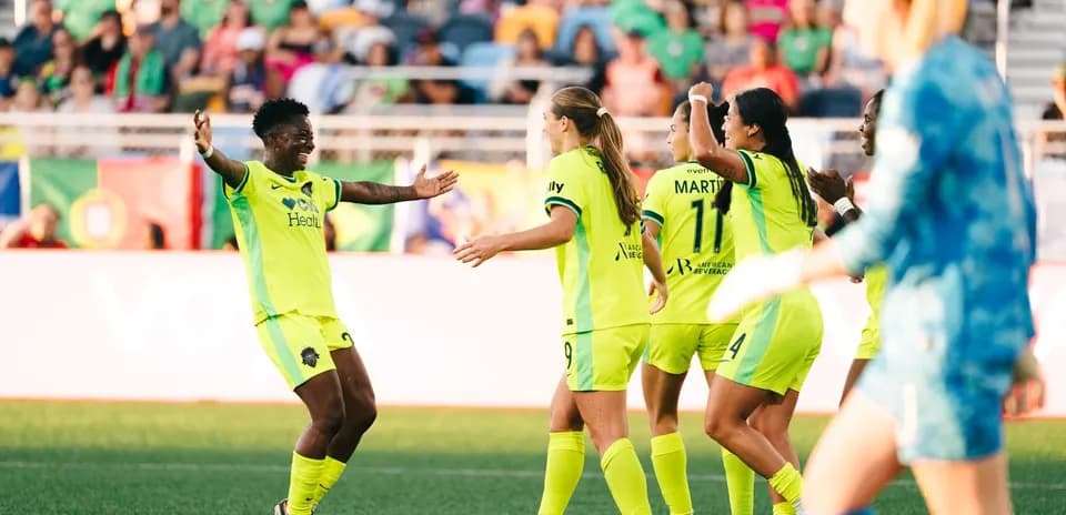 Players celebrating during NWSL match