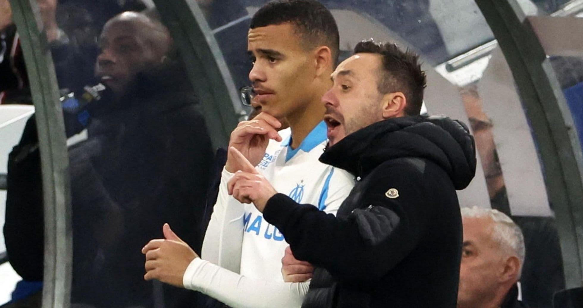 Coach giving instructions to player on sideline
