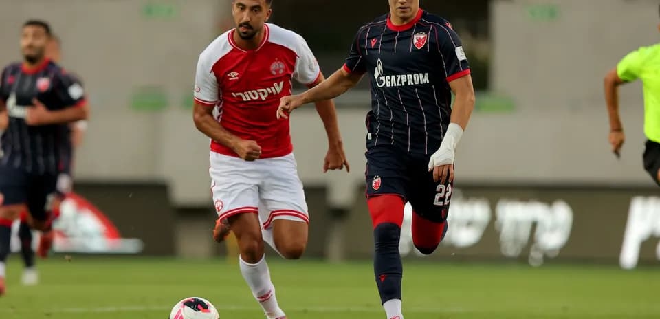 FK Crvena Zvezda player dribbling against opponent