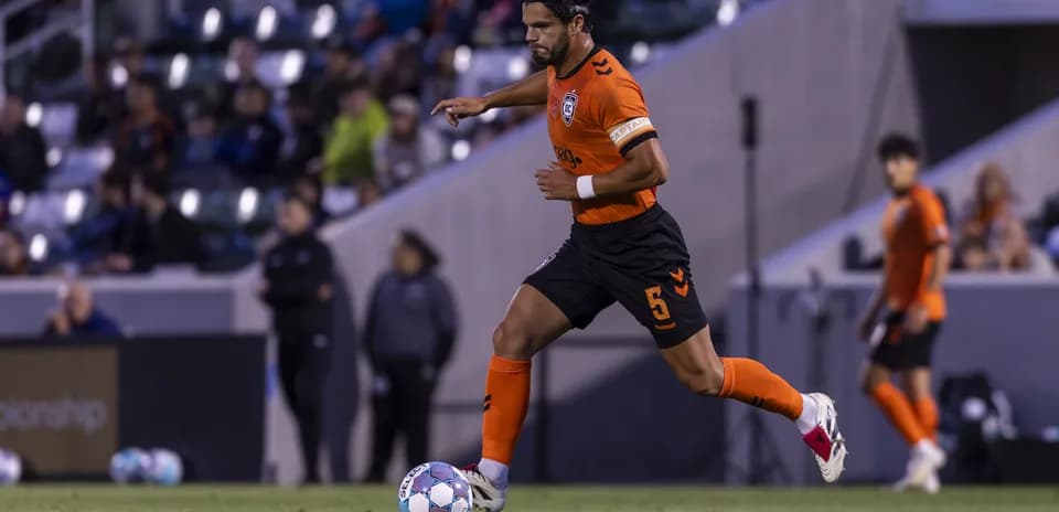Player running with ball during New Mexico United match