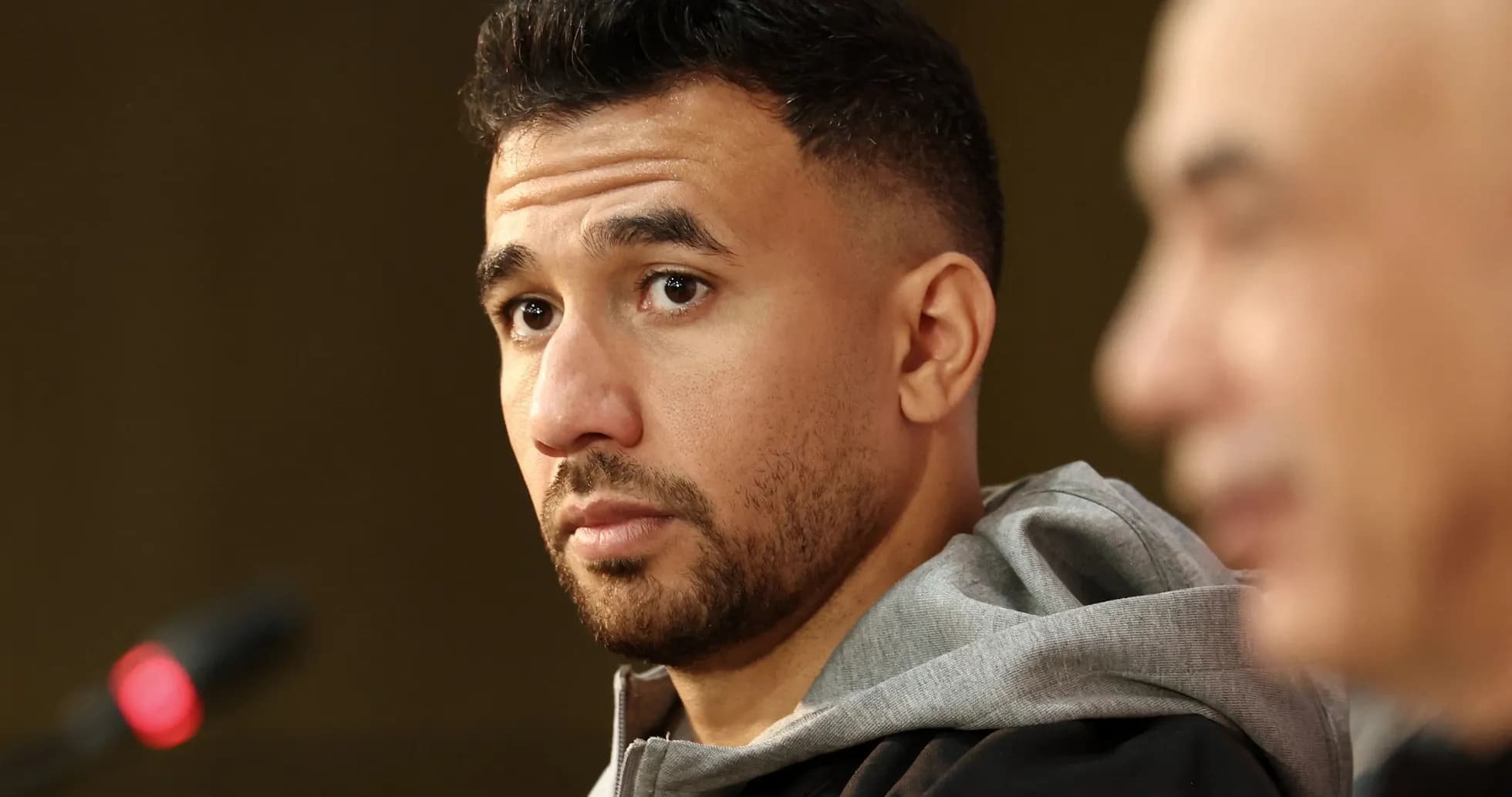 Athlete at press conference with microphone in view