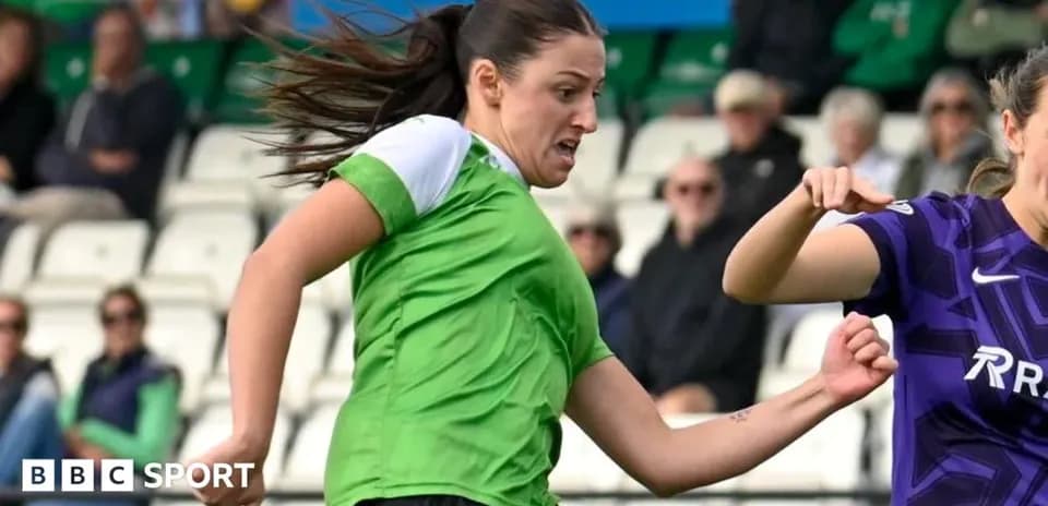 Player in green kicking ball during match action
