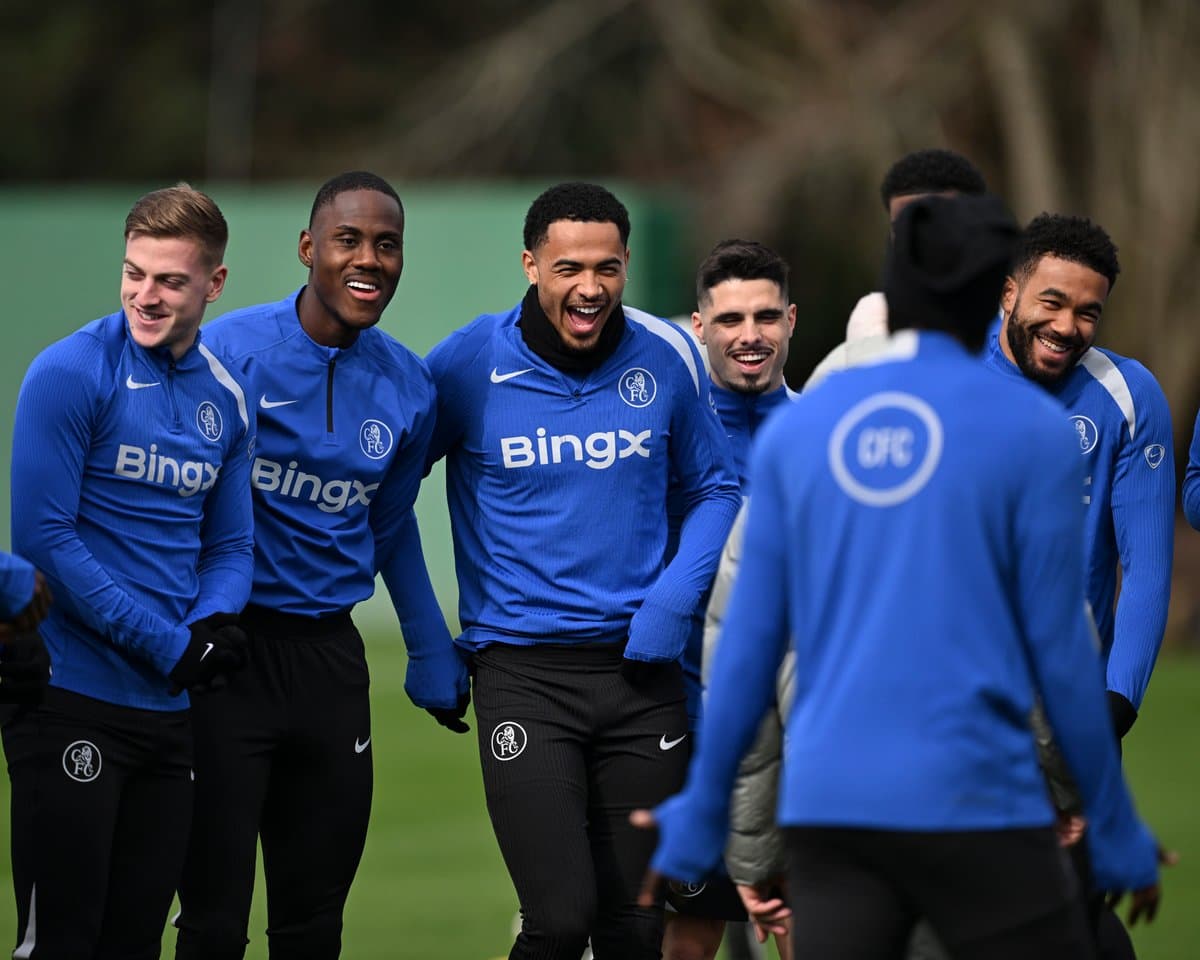 Players laughing during training session in blue kits