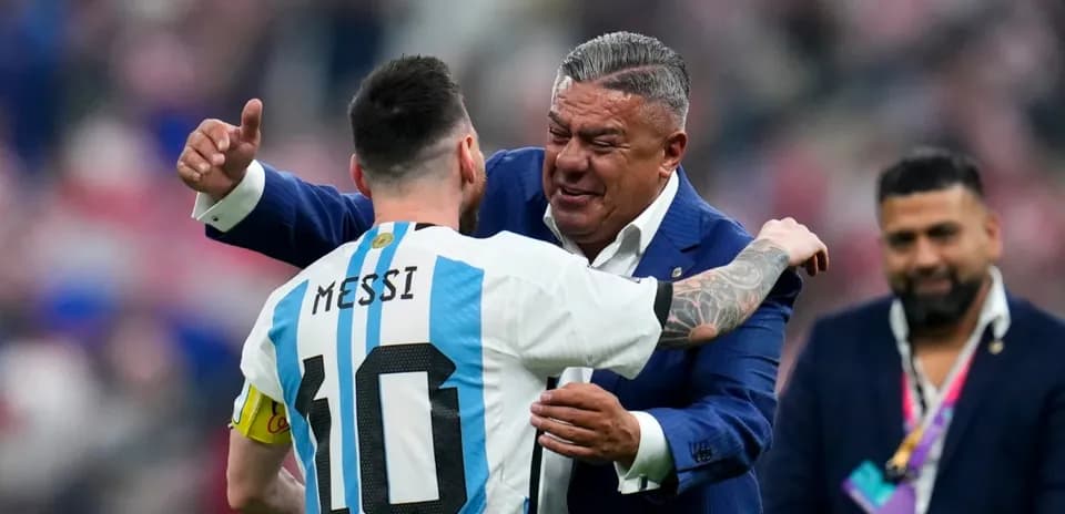 Lionel Messi embracing a coach after a match