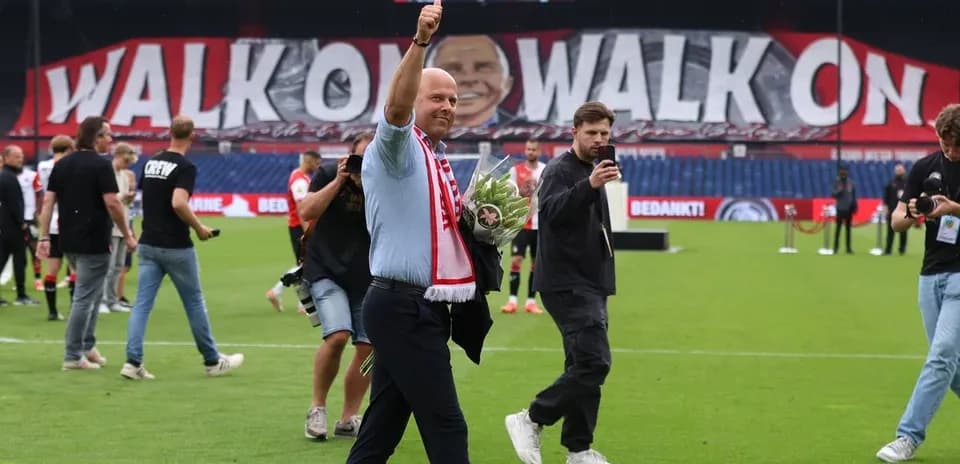 Man waving with flowers during stadium celebration