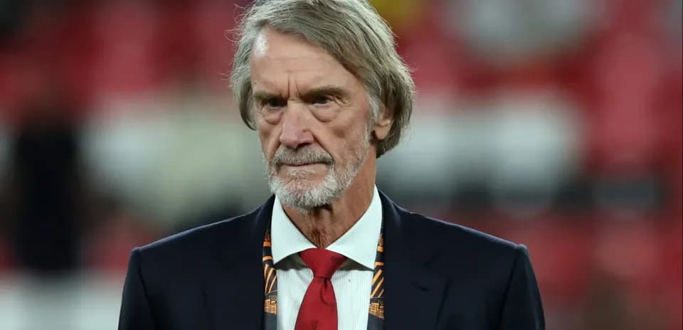 Man in suit with red tie at sports event