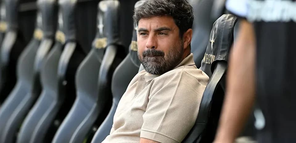Coach sitting on bench during match preparation