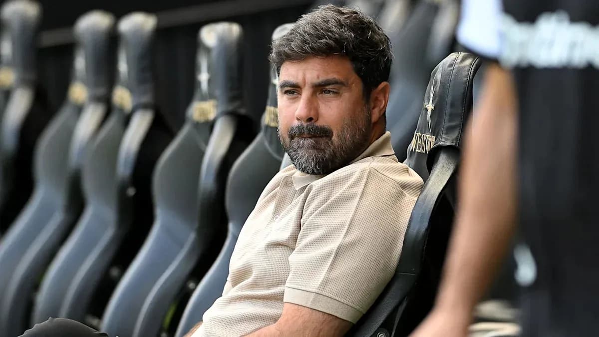 Coach sitting on bench during match preparation