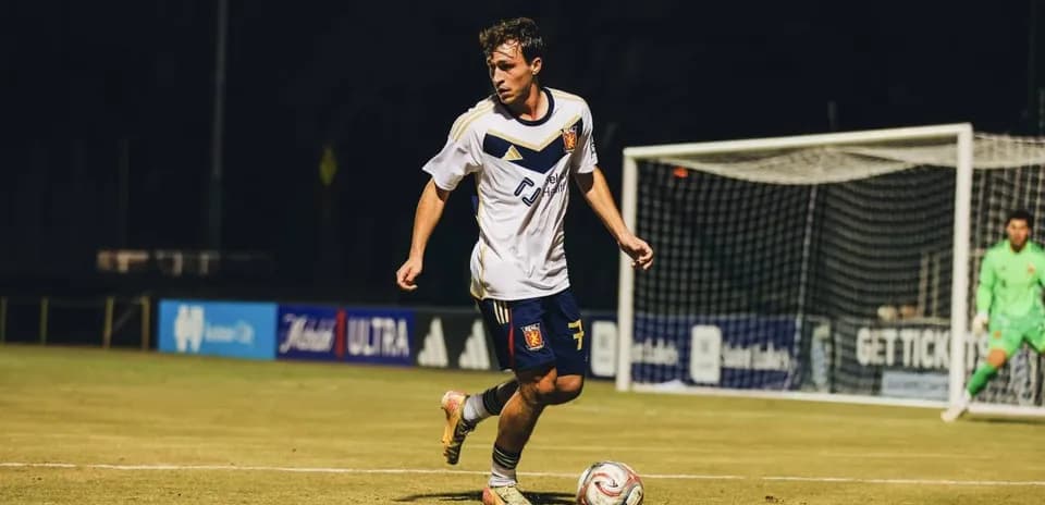 Real Monarchs player dribbling the ball on field