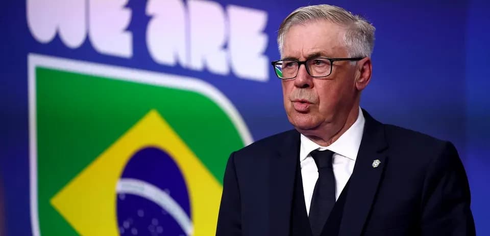 Man speaking in front of Brazil flag backdrop