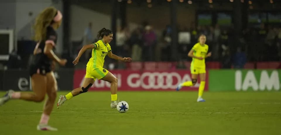 Player dribbling ball during NWSL match